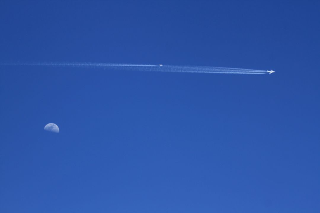 Airplane Leaving Contrail with Moon in Daytime Sky Over California - Free Images, Stock Photos and Pictures on Pikwizard.com
