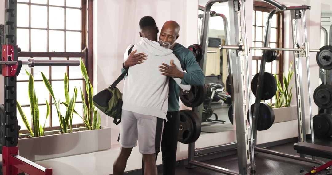 Gym Trainer and Client Sharing Hug After Successful Workout Session