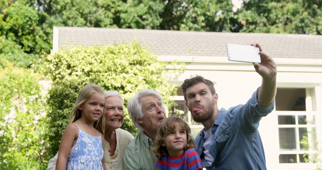 Multigenerational Family Taking Outdoor Selfie in Sunny Backyard - Free Images, Stock Photos and Pictures on Pikwizard.com