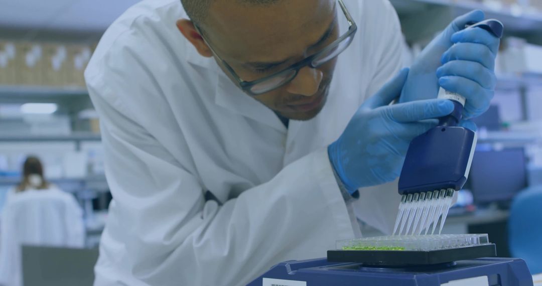 Scientist Dispensing Liquid into 96-Well Plate in Research Laboratory