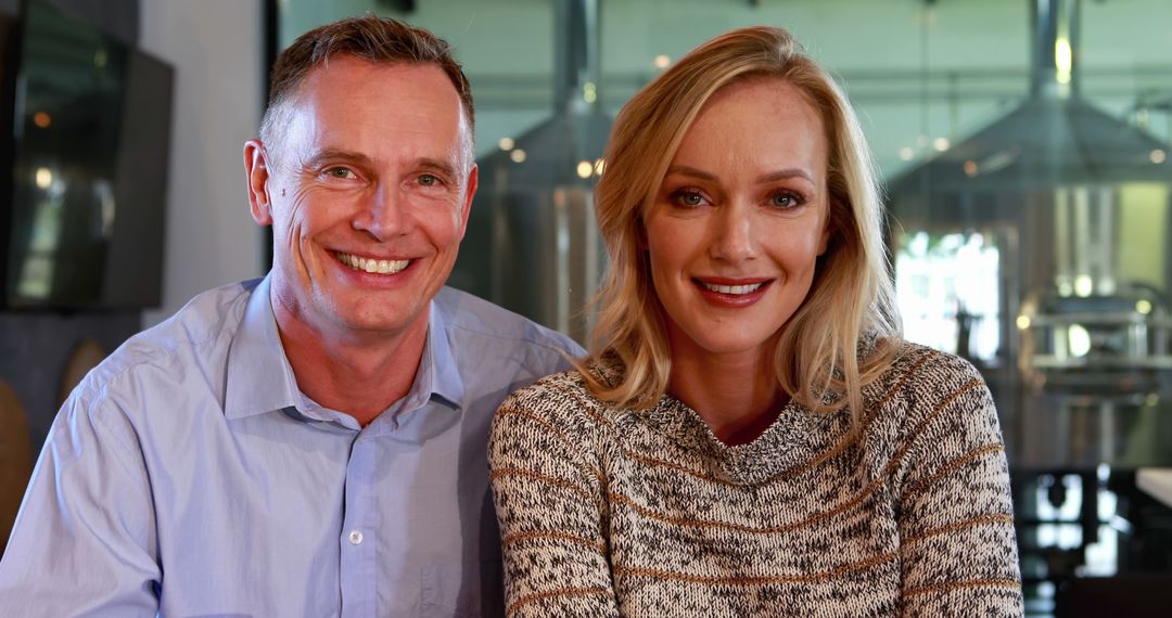 Smiling Middle-Aged Man and Woman Business Colleagues at Work