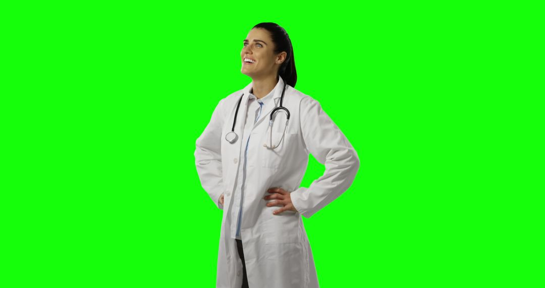 Confident Female Doctor Smiling and Looking Up on Green Screen - Free Images, Stock Photos and Pictures on Pikwizard.com