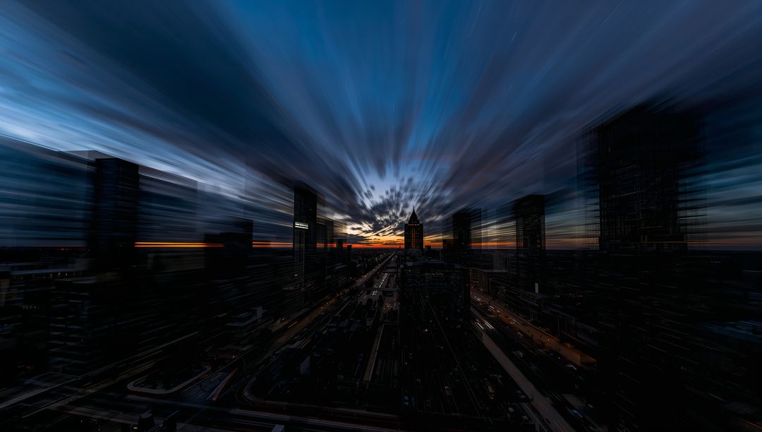 Framing pointed-roof tower silhouetting at sunset with radial motion streaks, light trails
