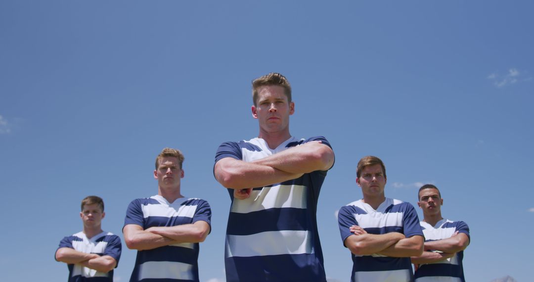 Confident Rugby Team Posing on Field Under Blue Sky - Free Images, Stock Photos and Pictures on Pikwizard.com