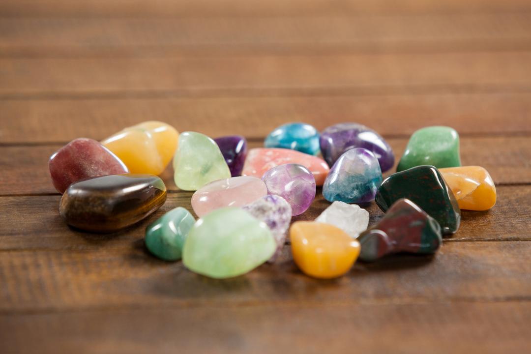 Colorful Polished Gemstones on Wooden Surface - Free Images, Stock Photos and Pictures on Pikwizard.com