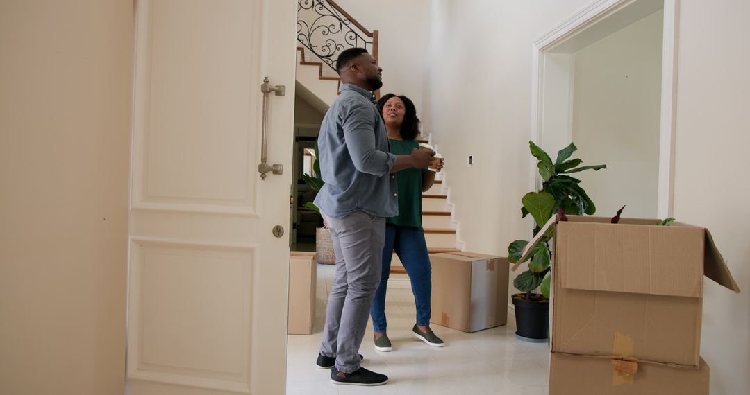 Couple Moving Into New Home with Joyful Expressions