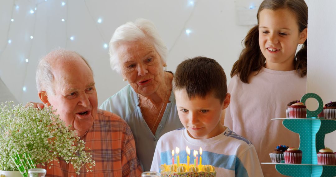 Family Celebrating Grandson's Birthday with Cake and Candles - Free Images, Stock Photos and Pictures on Pikwizard.com