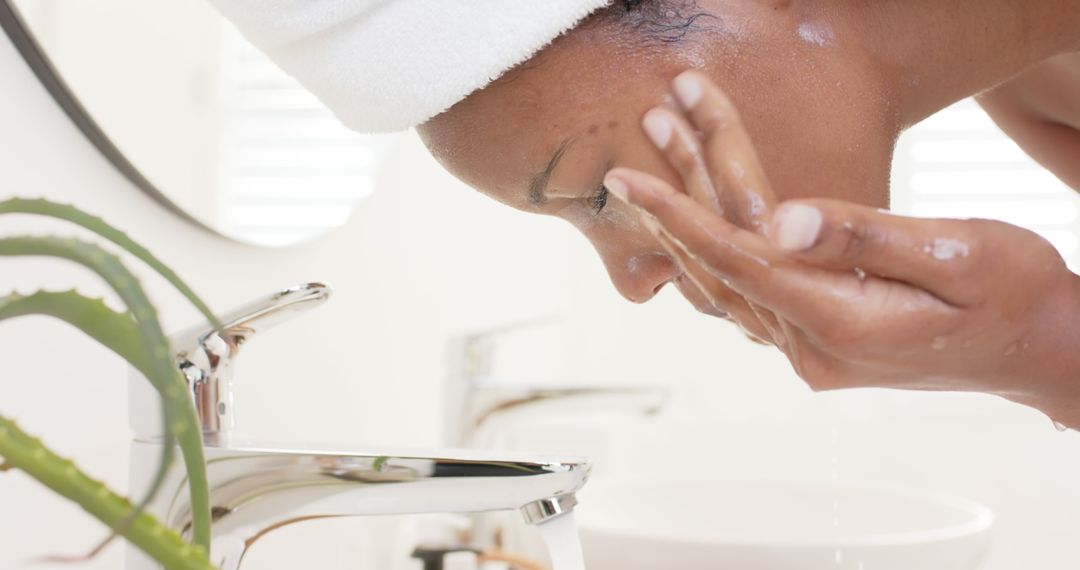 Woman Washing Face with Water in Bathroom - Free Images, Stock Photos and Pictures on Pikwizard.com