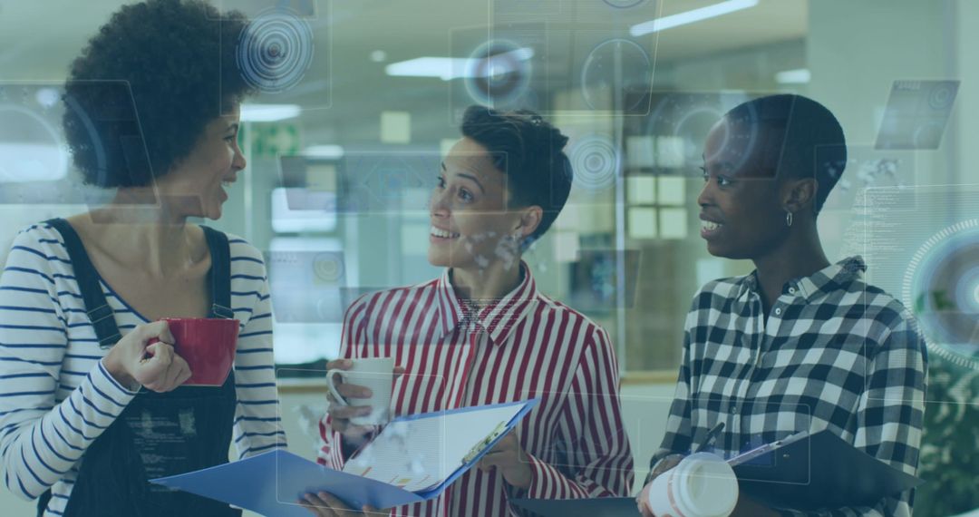 Diverse Female Colleagues Utilizing Technology During Coffee Break