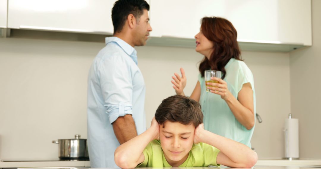 Parents arguing while child looks stressed in kitchen - Free Images, Stock Photos and Pictures on Pikwizard.com