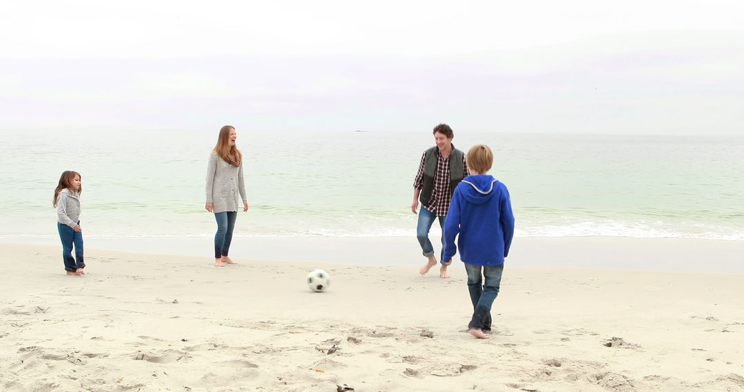 Family Playing Soccer on Beach in Casual Attire - Free Images, Stock Photos and Pictures on Pikwizard.com