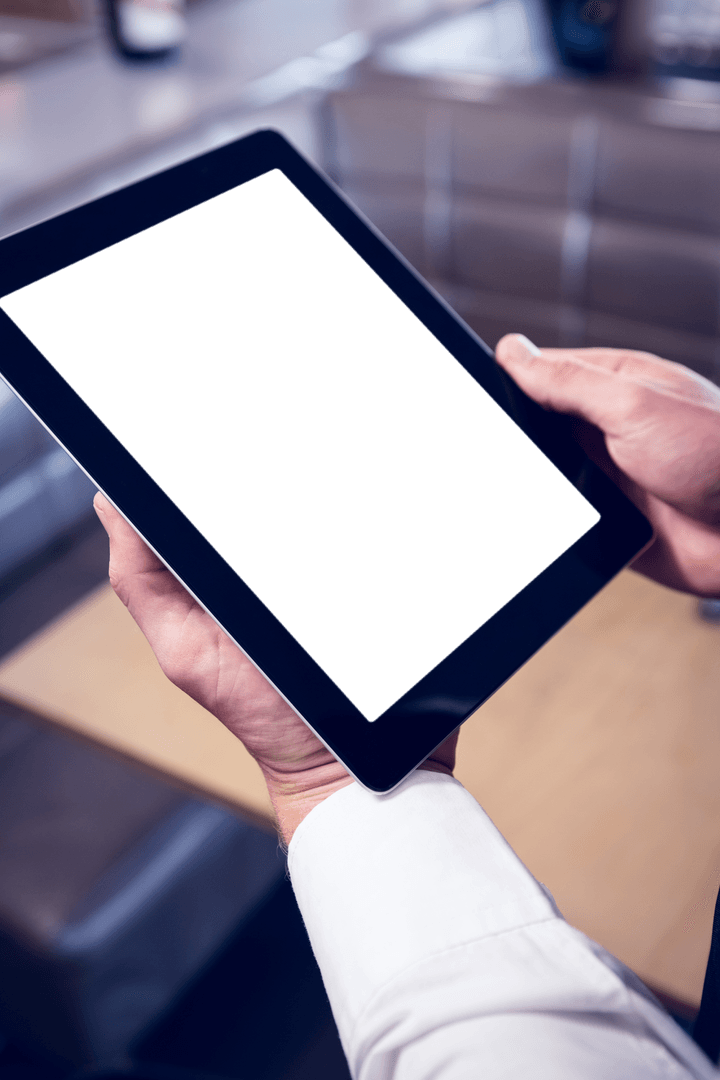 Transparent Digital Tablet Held by Businessman in Cafe Setting