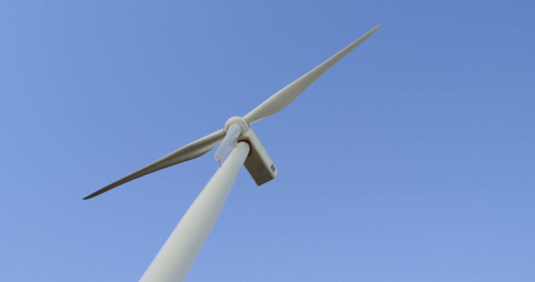 Closeup of Wind Turbine Against Clear Blue Sky - Free Images, Stock Photos and Pictures on Pikwizard.com