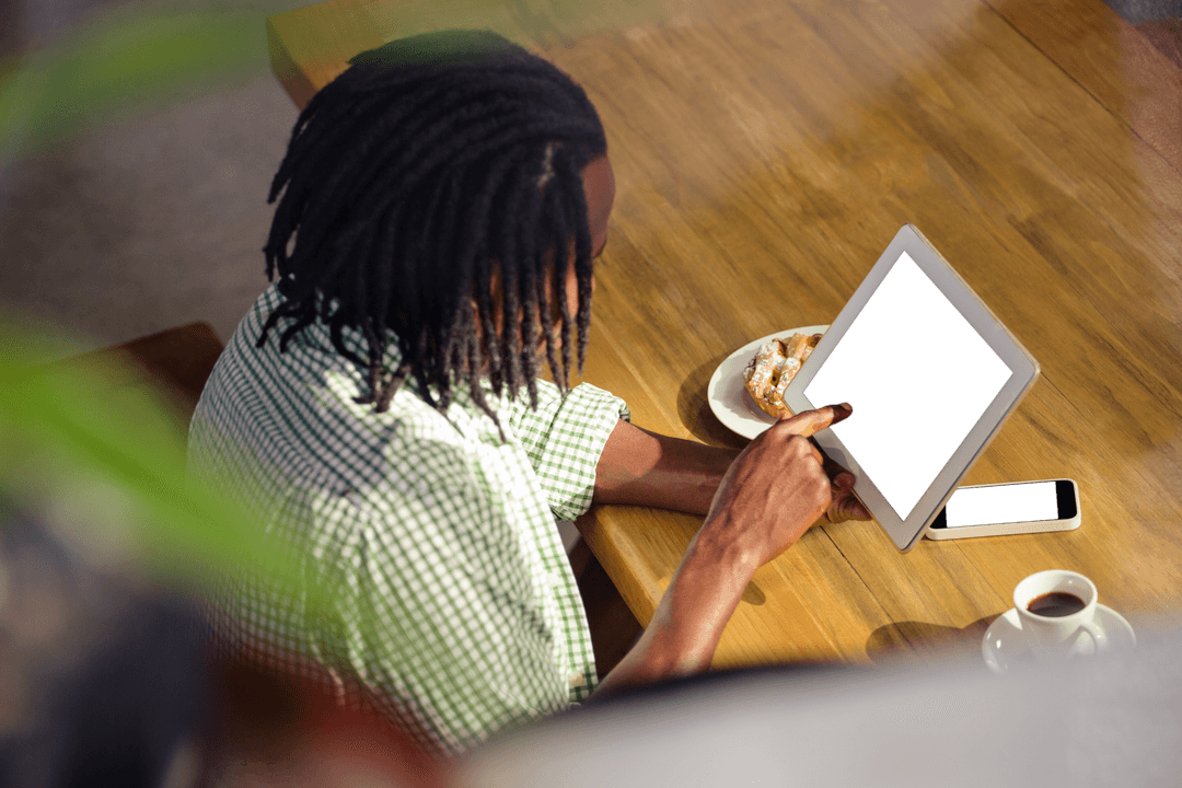 High Angle View of Man Using Tablet at Cafe with Coffee