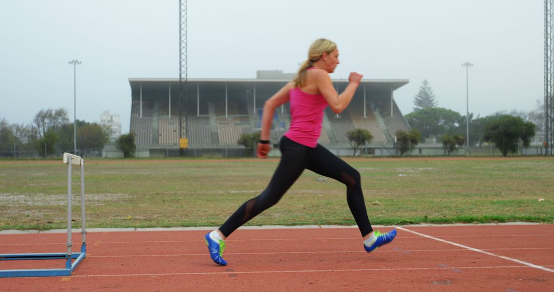 Female Athlete Sprinting on Outdoor Track - Free Images, Stock Photos and Pictures on Pikwizard.com