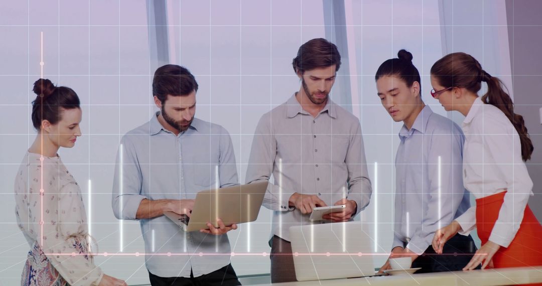 Team Collaborating with Laptops and Tablets on Data Project