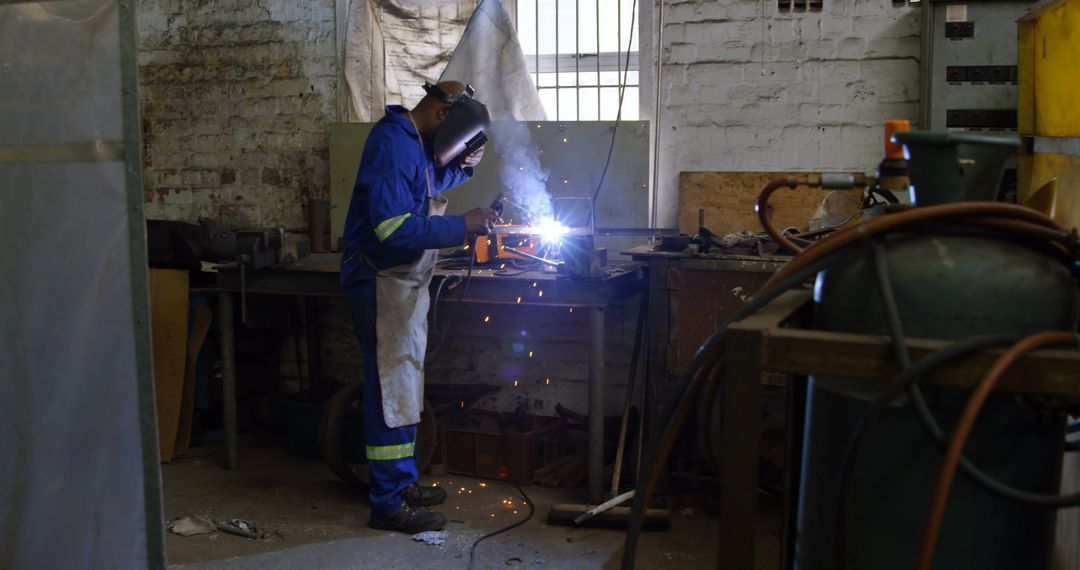 Worker Welding in a Workshop with Protective Gear - Free Images, Stock Photos and Pictures on Pikwizard.com