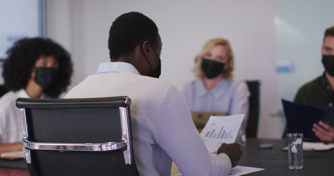 Diverse Team Meeting with Masks in Modern Office