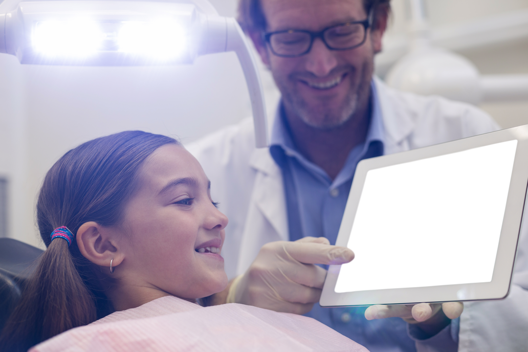 Dentist Using Tablet Explained to Smiling Child Patient with Transparent Dentist Tools - Download Free Stock Images Pikwizard.com