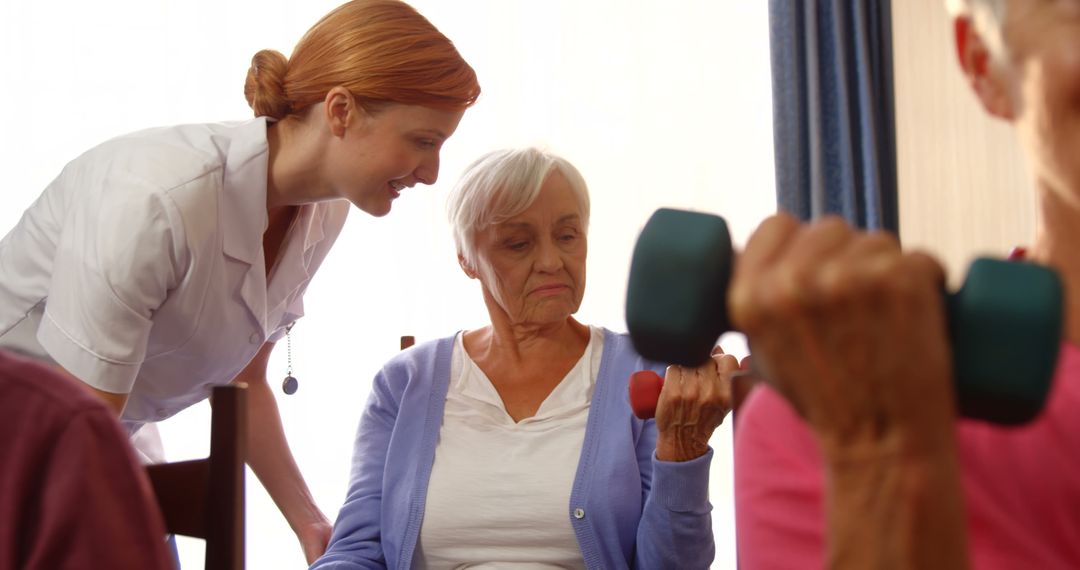 Physiotherapist Assisting Senior Woman with Hand Weights - Free Images, Stock Photos and Pictures on Pikwizard.com