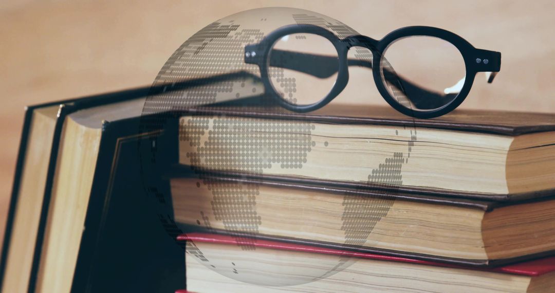 Glasses on Books with Digitized globe symbolizing Education and Connection