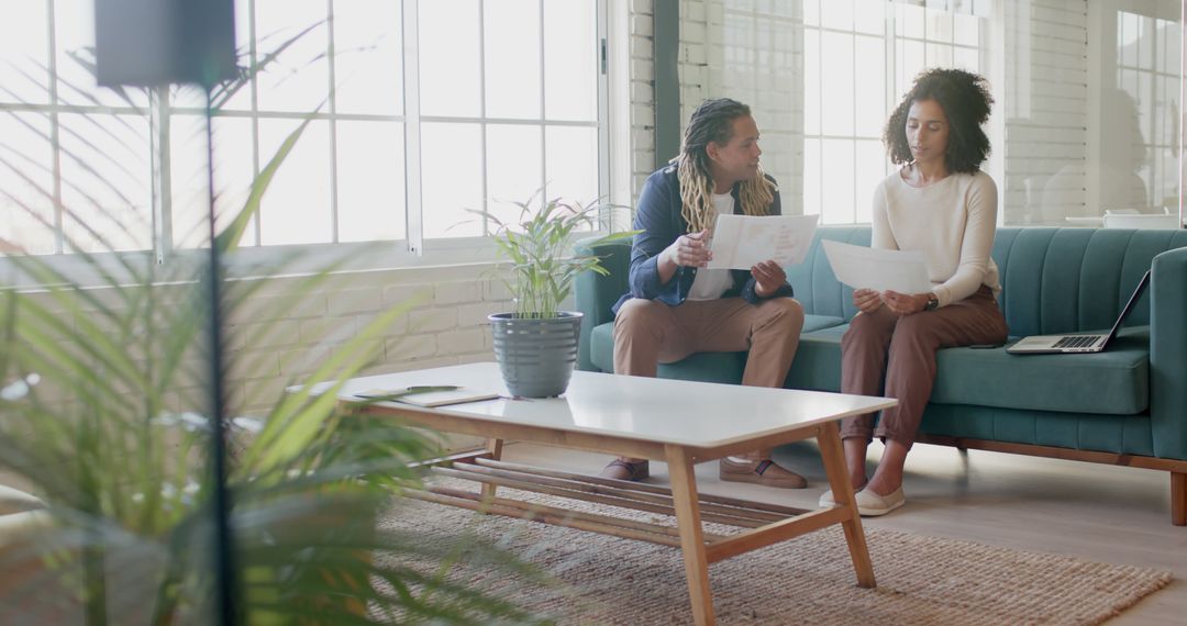 Diverse Professionals Analyzing Reports in Modern Office