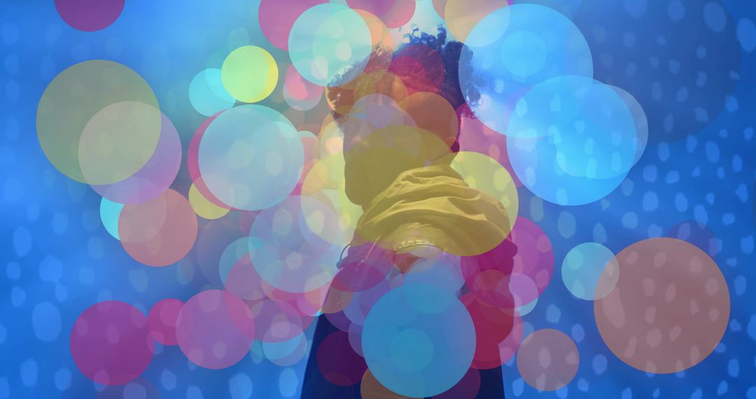 Silhouette Person with Colorful Bokeh Effects Against Futuristic Blue Background
