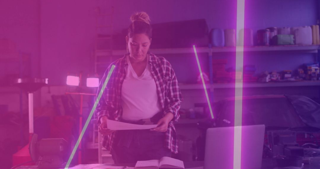 Technician Reviewing Blueprints in Modern Garage Workshop