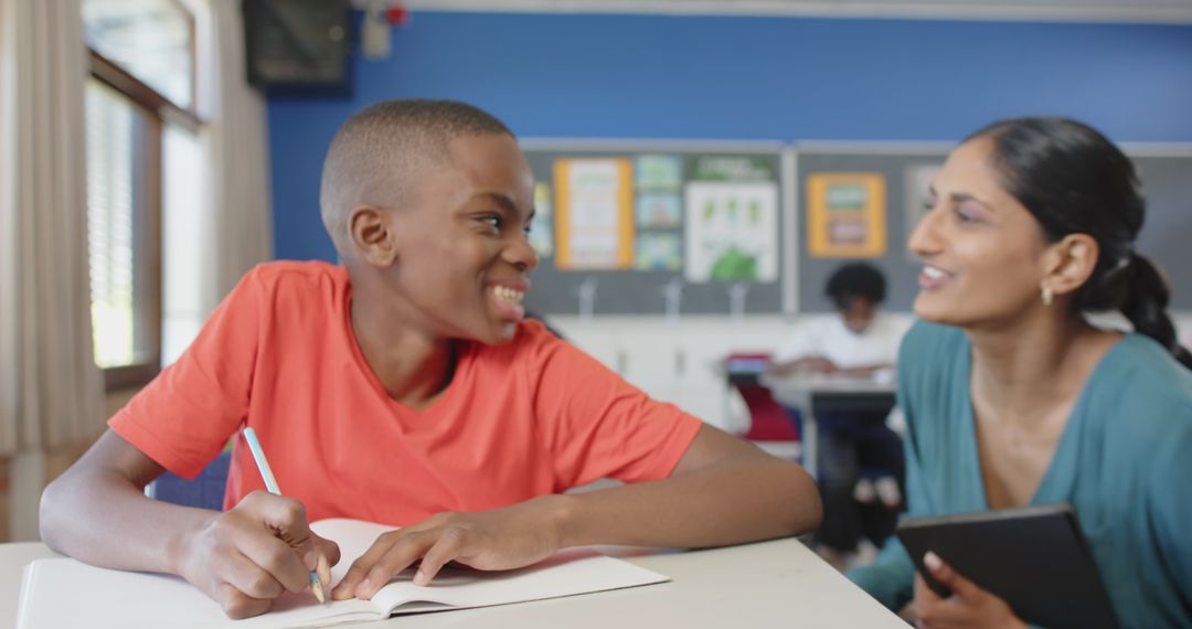 Educator Assisting Student Writing in Classroom Setting