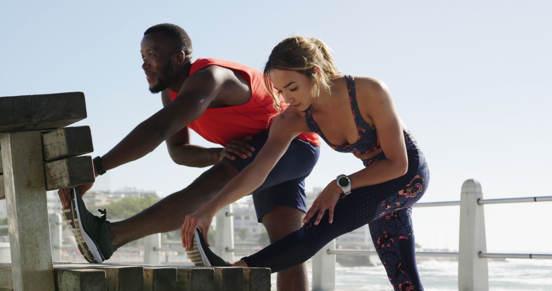 Two Fit Individuals Stretching Before Outdoor Workout by Sea - Free Images, Stock Photos and Pictures on Pikwizard.com