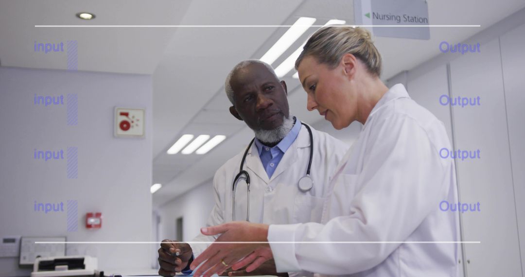 Two Doctors Reviewing Patient Charts at Nursing Station Collaborating on Care Plan