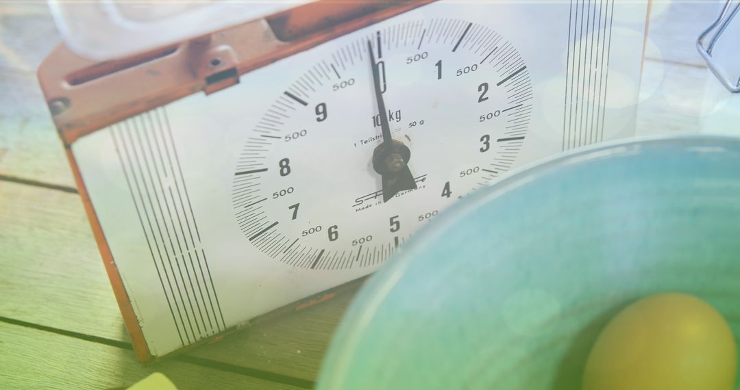 Vintage Kitchen Scale and Bowl with Eggs on Rustic Wooden Surface