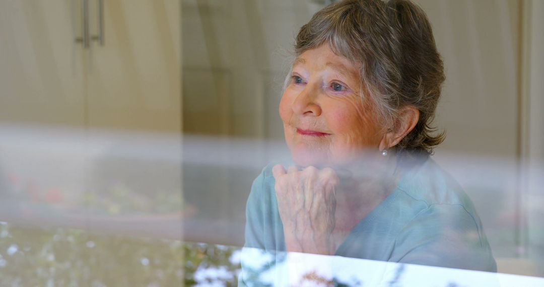 Pensive Older Woman Looking Through Window at Home - Free Images, Stock Photos and Pictures on Pikwizard.com