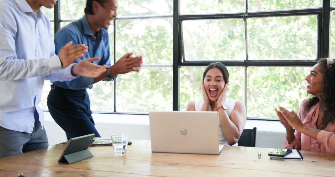 Happy Team Celebrating Success in a Modern Office Space