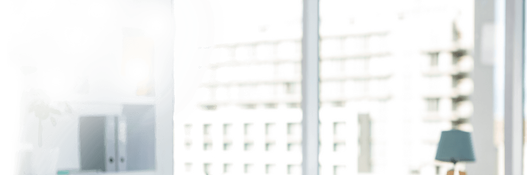 Brightly Lit Office With Large Transparent Glass Windows View On Urban cityscape