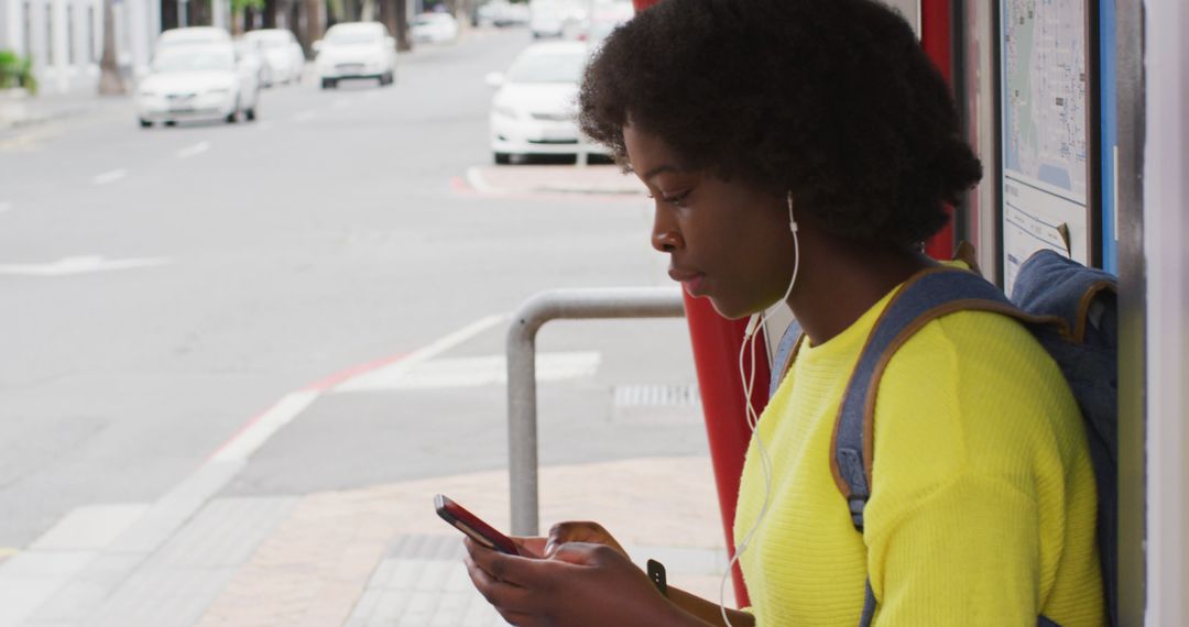 Young Woman Waiting at Bus Stop Using Smartphone - Free Images, Stock Photos and Pictures on Pikwizard.com