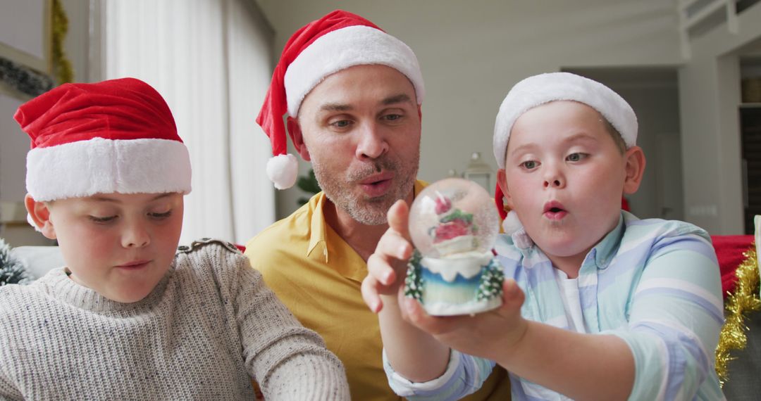 Excited Family Enjoying Christmas Snow Globe Together - Free Images, Stock Photos and Pictures on Pikwizard.com