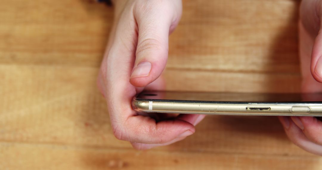 Hands Charging Smartphone on Wooden Table - Free Images, Stock Photos and Pictures on Pikwizard.com