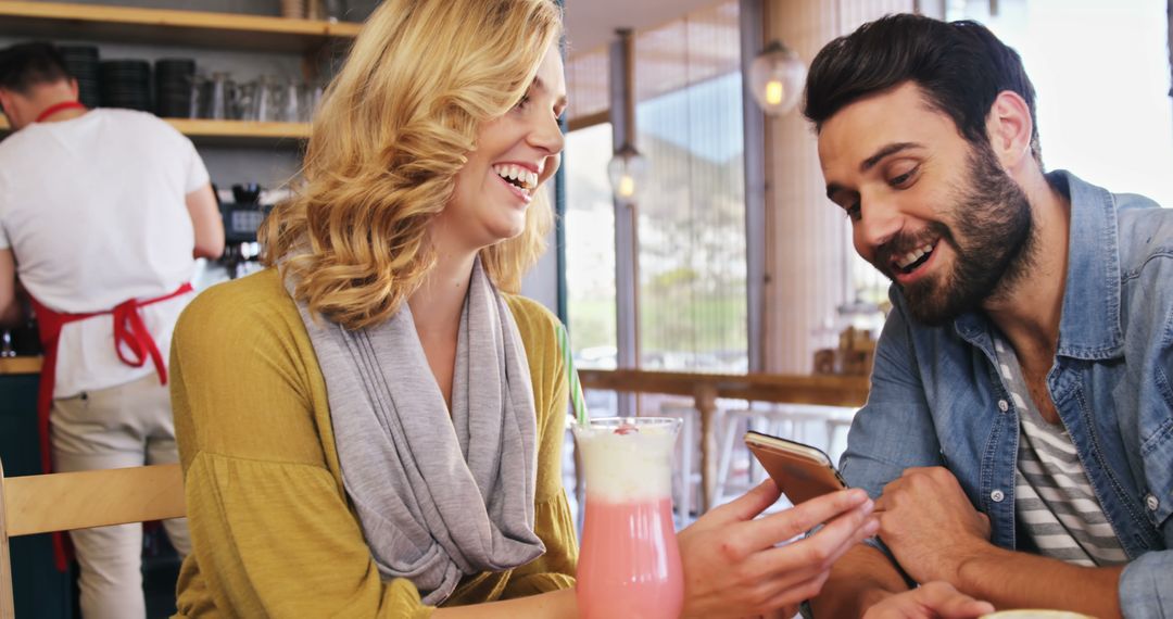 Couple Enjoying Coffee and Smartphone at Cozy Cafe