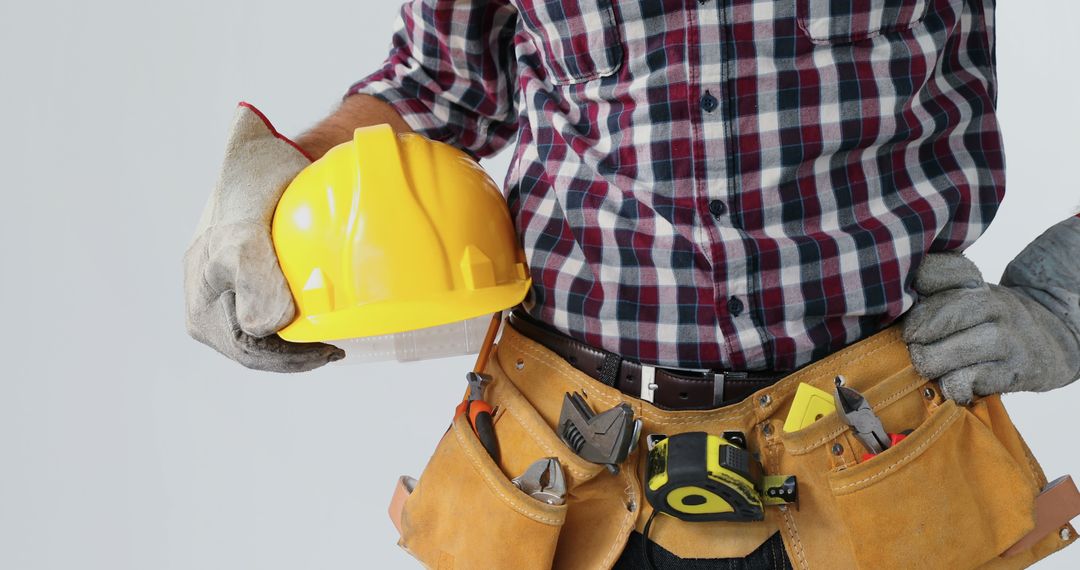 Construction Worker with Tool Belt and Hard Hat in Hand - Free Images, Stock Photos and Pictures on Pikwizard.com