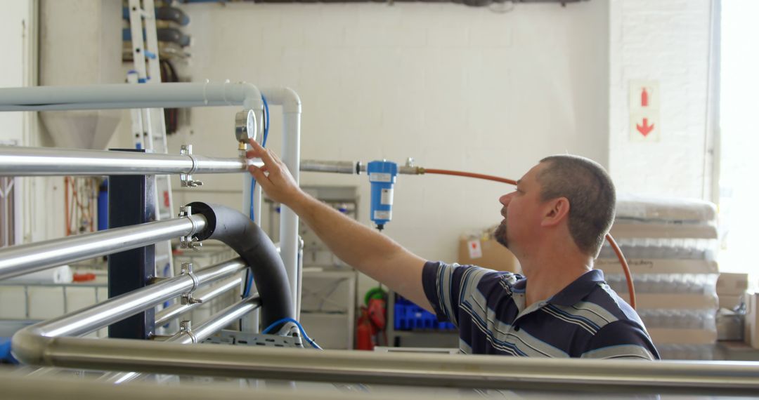 Industrial Technician Adjusting Pressure Gauge in Factory - Free Images, Stock Photos and Pictures on Pikwizard.com