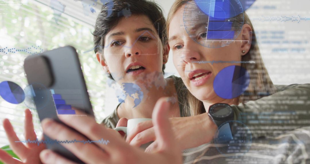 Two women exploring mobile analytics with augmented data overlays, collaborating at home