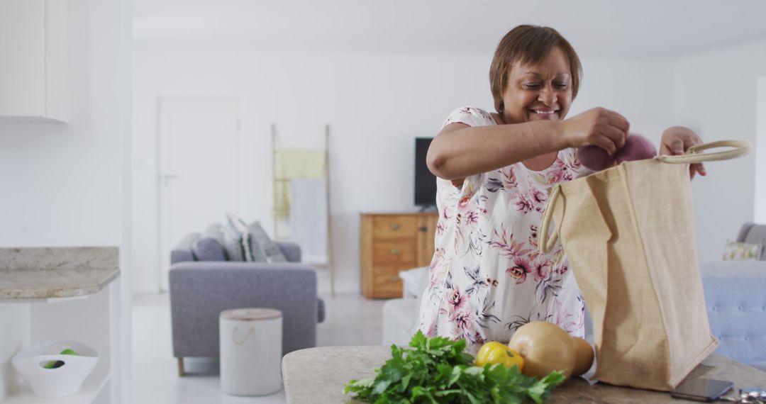 Senior Woman Unpacking Groceries in Modern Kitchen - Free Images, Stock Photos and Pictures on Pikwizard.com