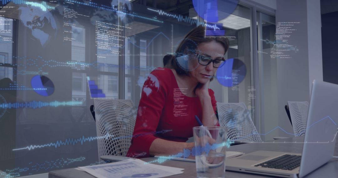 Businesswoman Analyzing Data on Laptop with Dynamic Graphics Overlay