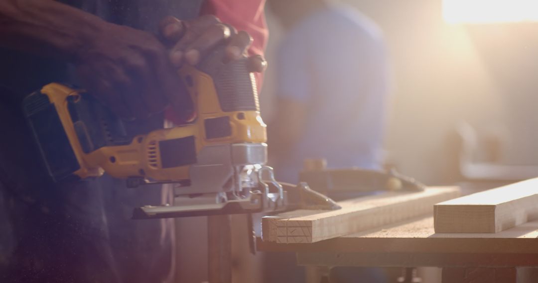 Woodworkers Collaborating in Workshop with Power Tools