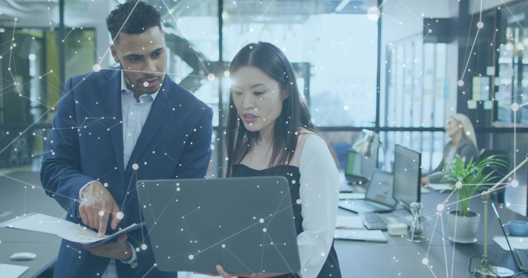 Professionals collaborating over laptop and documents in modern office with network overlay