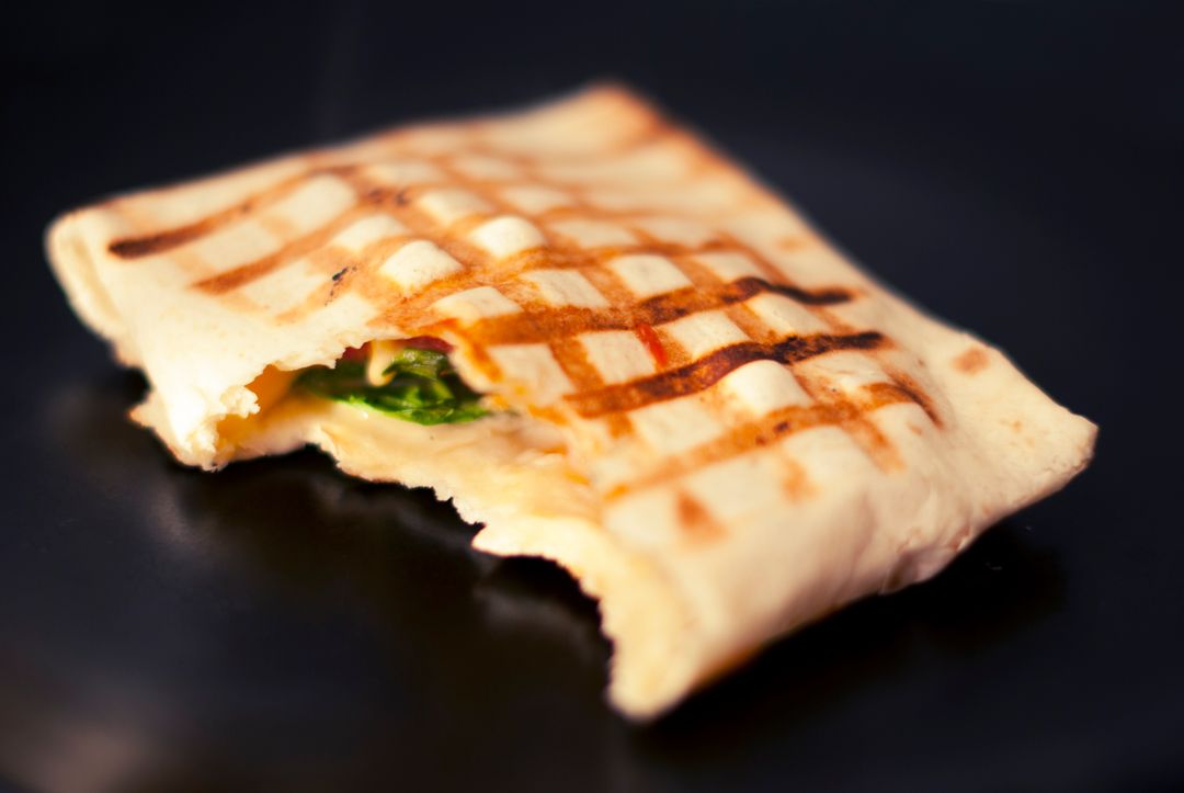 Close-Up of a Grilled Sandwich Wrap with Bite - Free Images, Stock Photos and Pictures on Pikwizard.com