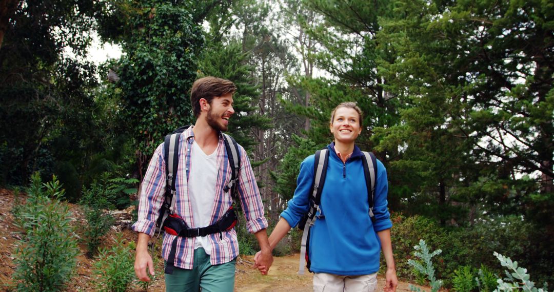 Couple Hiking Together Wearing Backpacks in Forest - Free Images, Stock Photos and Pictures on Pikwizard.com