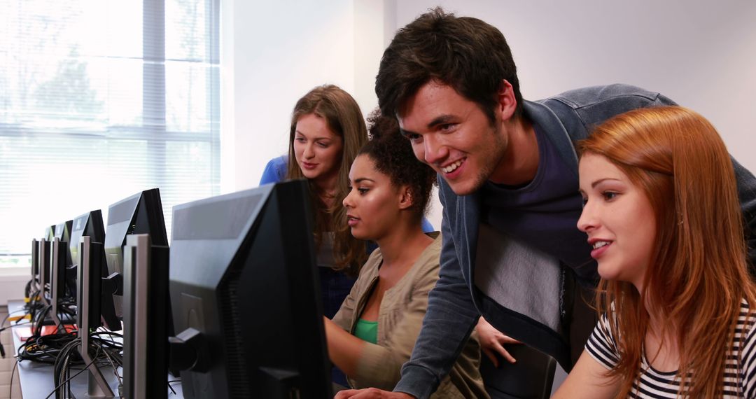 A diverse group of young students is engaged in a computer lab session, with copy space - Free Images, Stock Photos and Pictures on Pikwizard.com