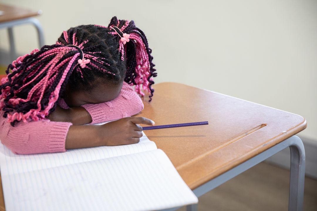 Young Student Resting at School Desk During Class
